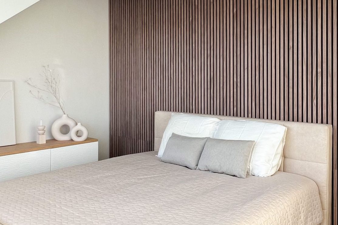 Walnut akupanel with a floor to ceiling headboard
